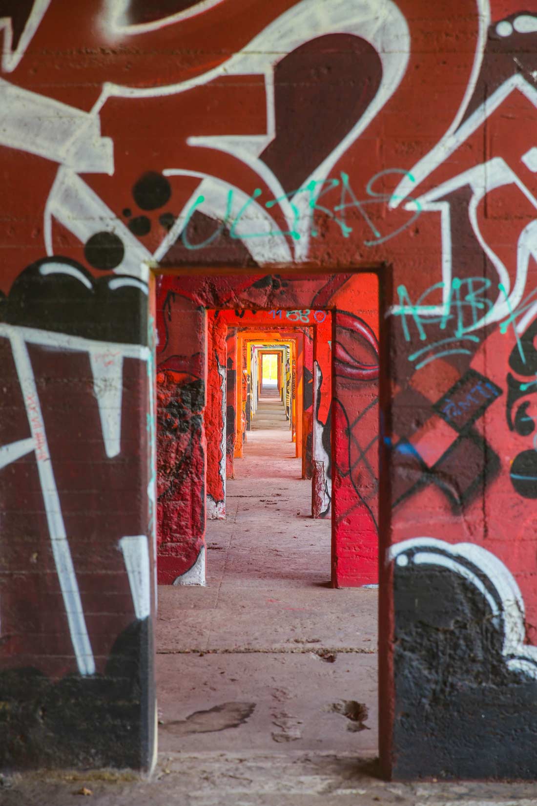 Durchgänge in einer verlassenen Industrieanlage mit Graffiti